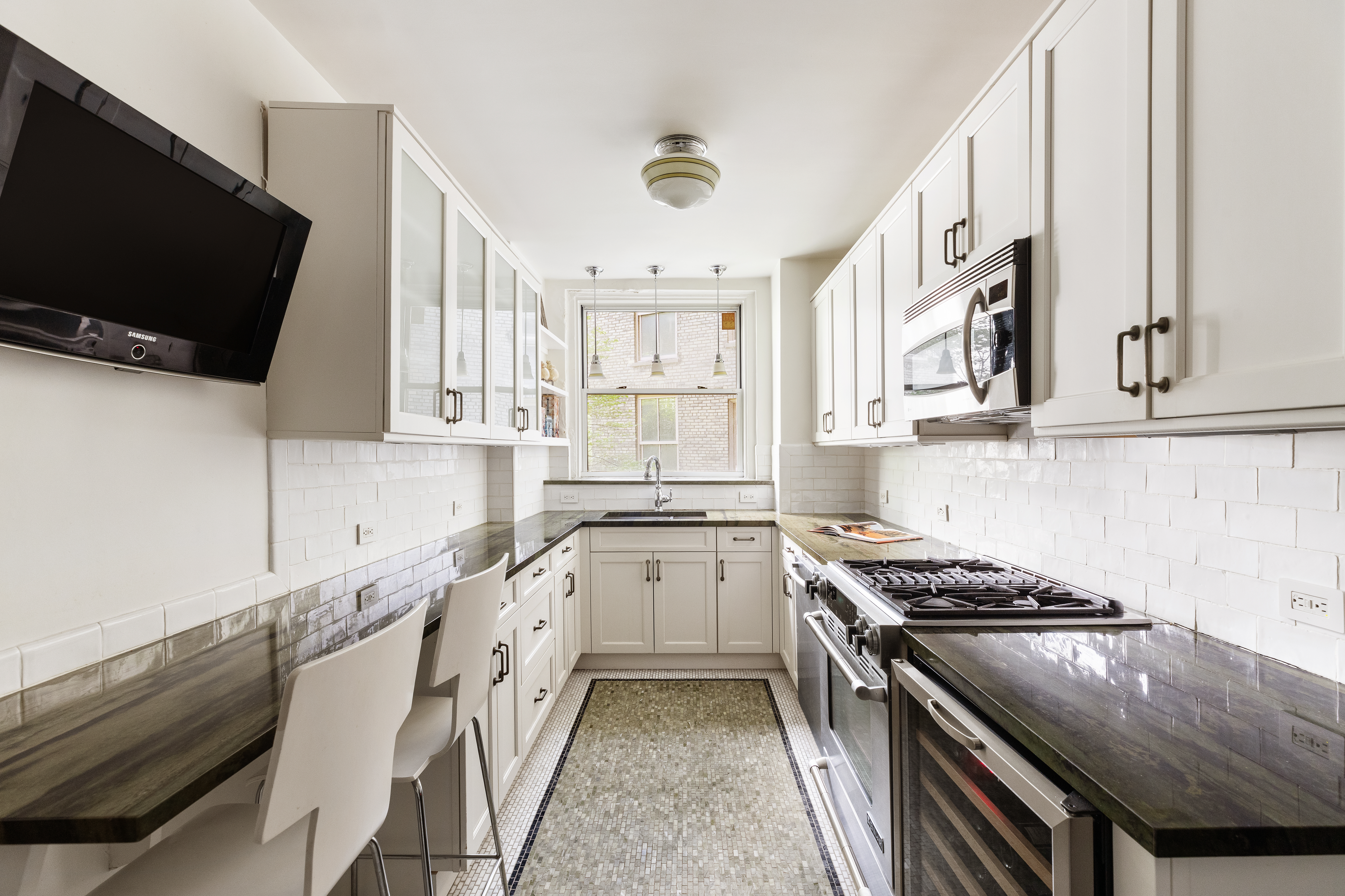 173-175 Riverside Drive, Unit 2L Manhattan, NY 10024 - Photo 8 of 18 a kitchen with stainless steel appliances granite countertop a stove and a sink