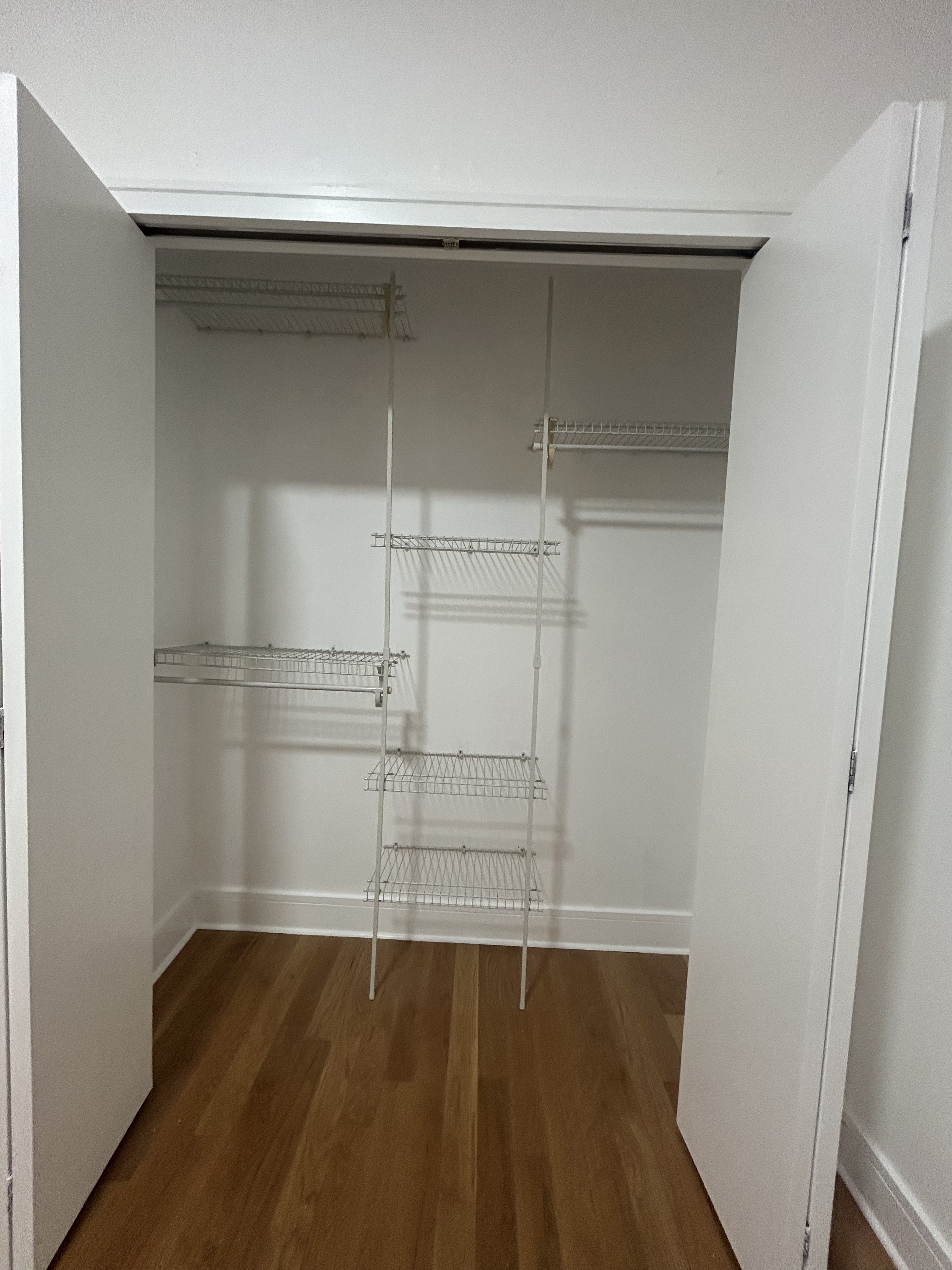 41-26 27th Street, Unit 4H Queens, NY 11101 - Photo 12 of 21 an empty room with wooden floor