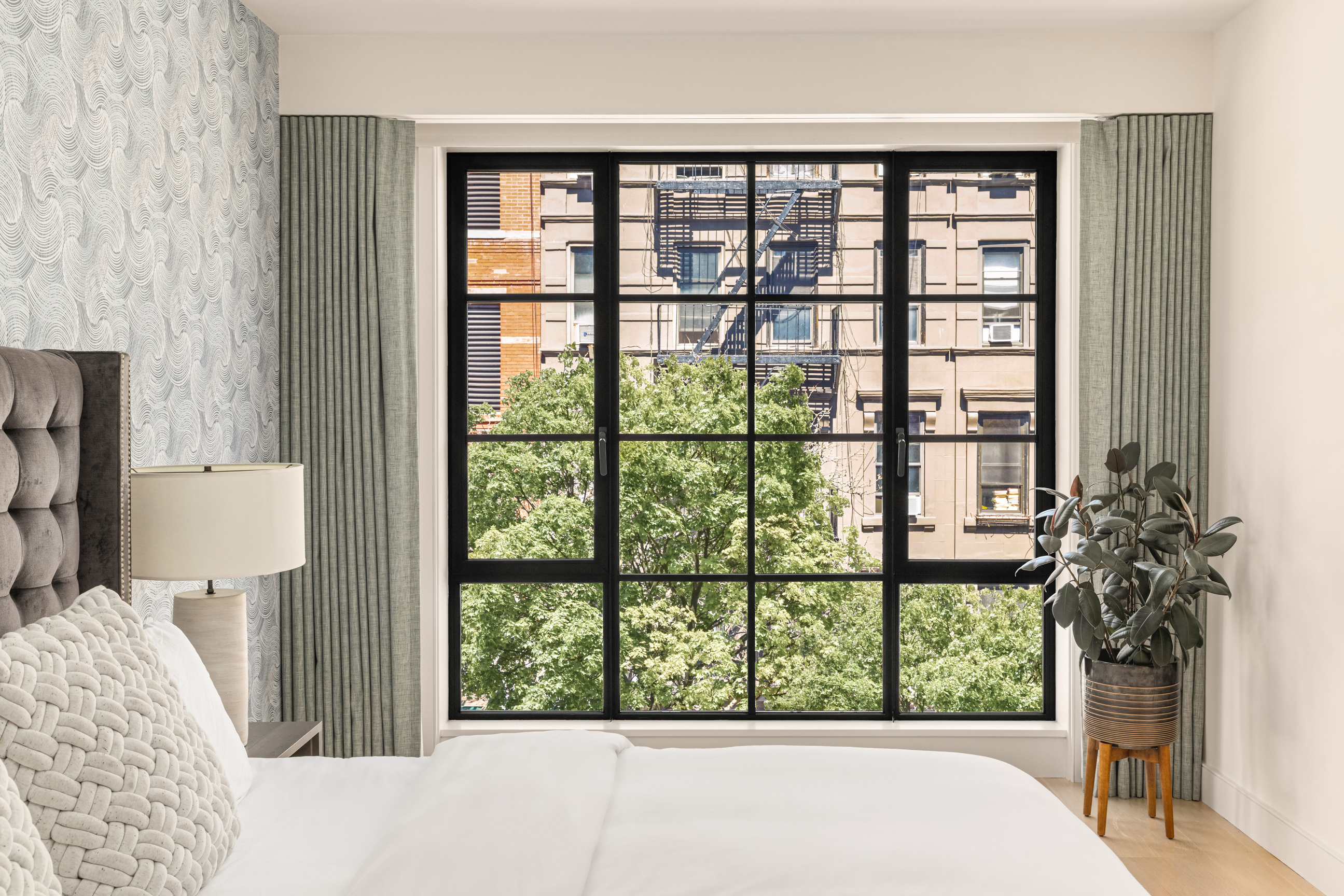 134 West 83rd Street, Unit 4 Manhattan, NY 10024 - Photo 10 of 17 a bed sitting in front of a window