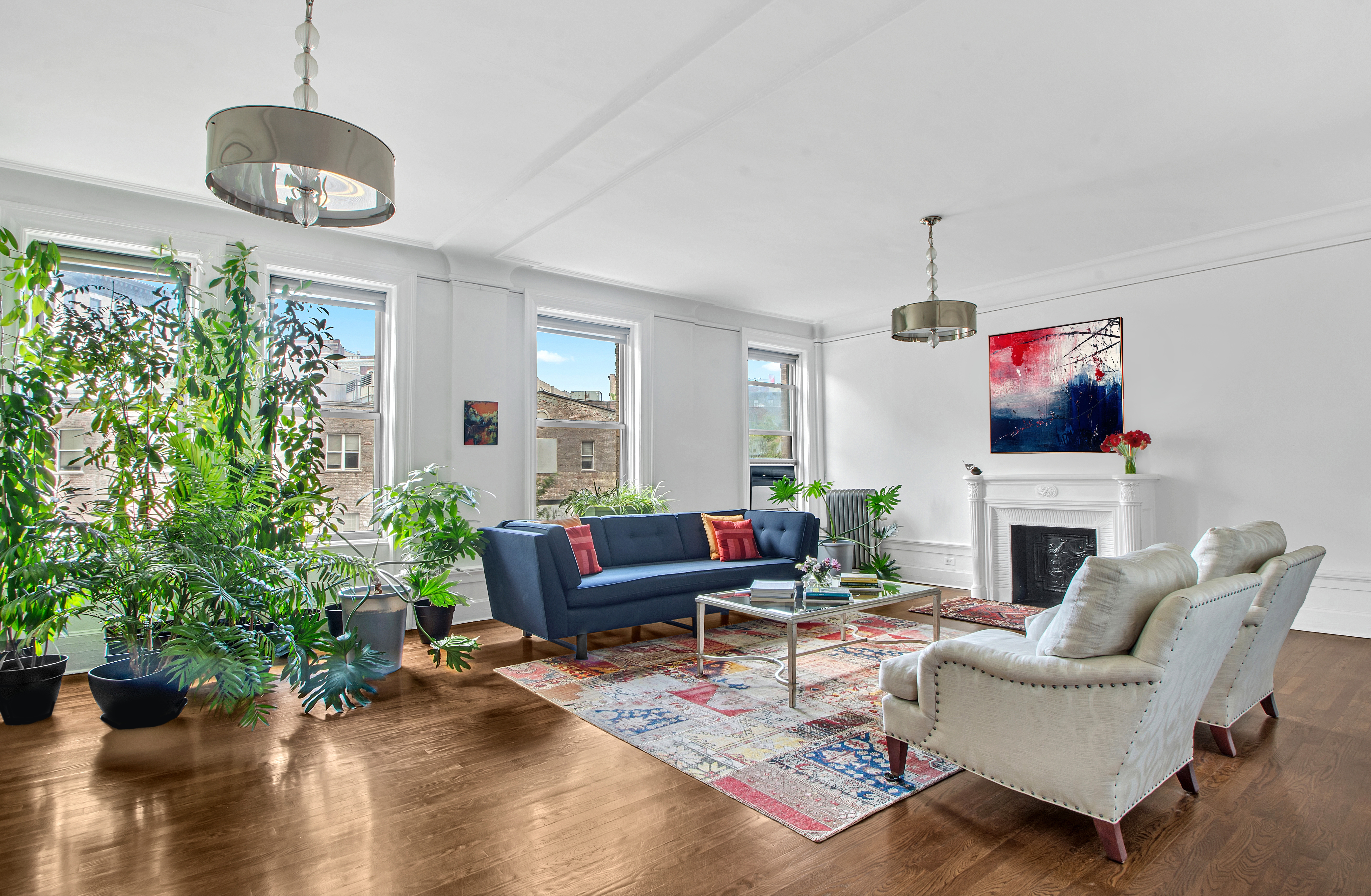 a living room with furniture potted plant floor and a window