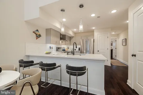 a kitchen with stainless steel appliances kitchen island granite countertop a sink and cabinets