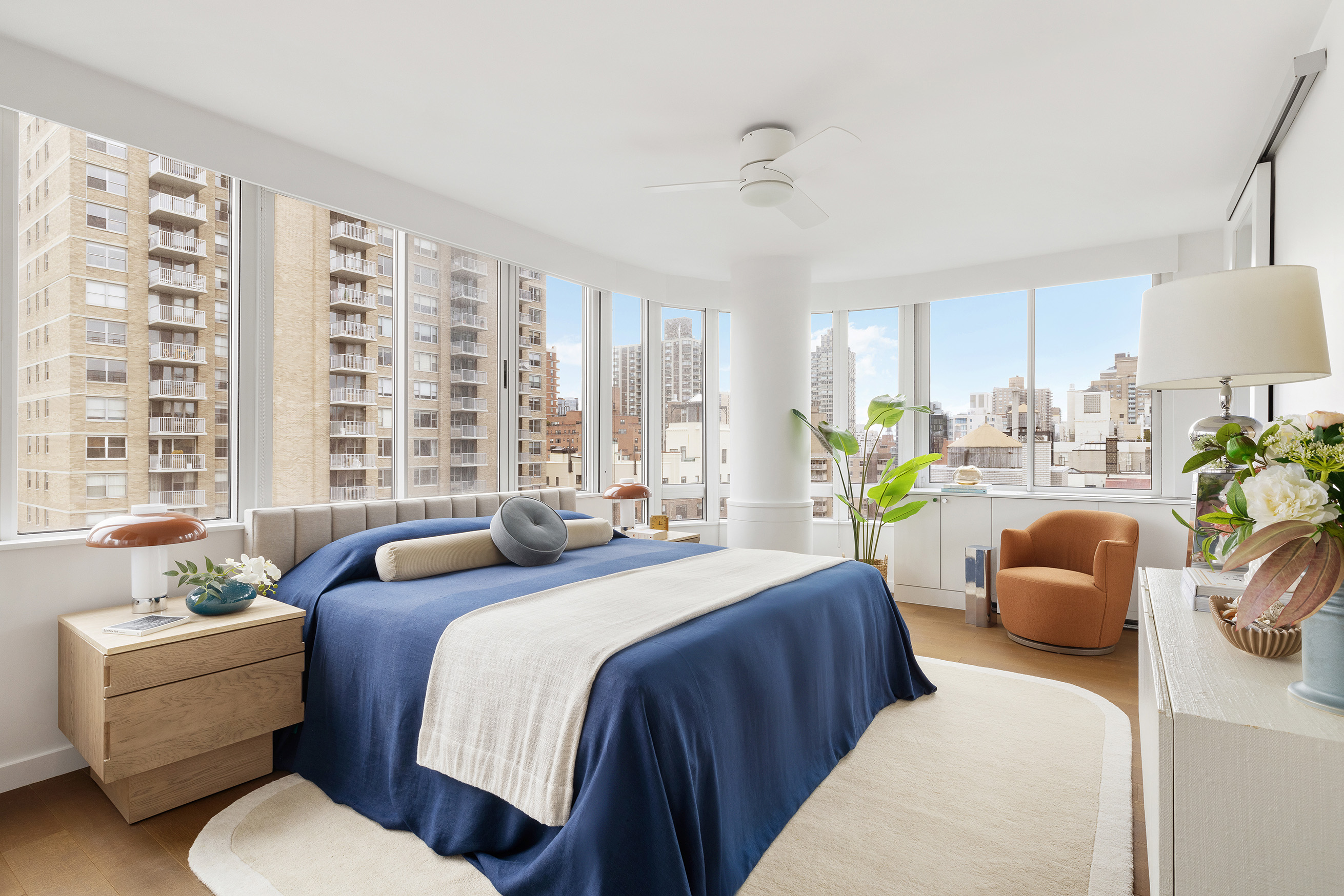 455 East 86th Street, Unit 20E Manhattan, NY 10028 - Photo 7 of 14 a bedroom with a bed couch and a large window