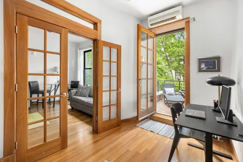 a view of a livingroom with furniture and a window