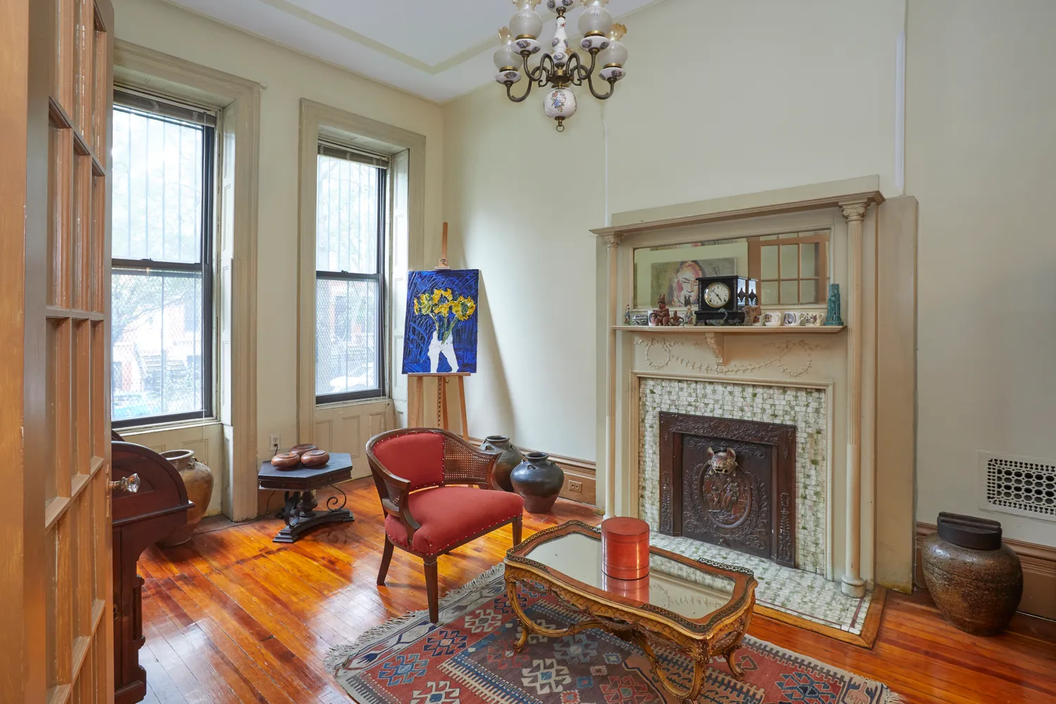 a living room with furniture a fireplace and a large window