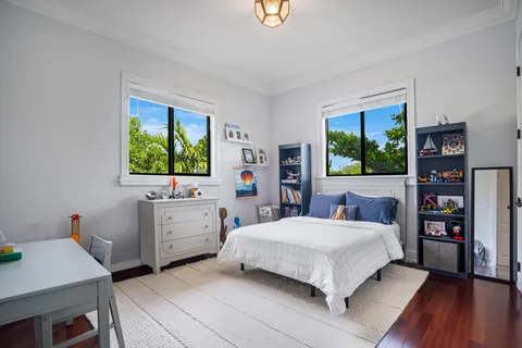 a bedroom with a bed and a desk in it