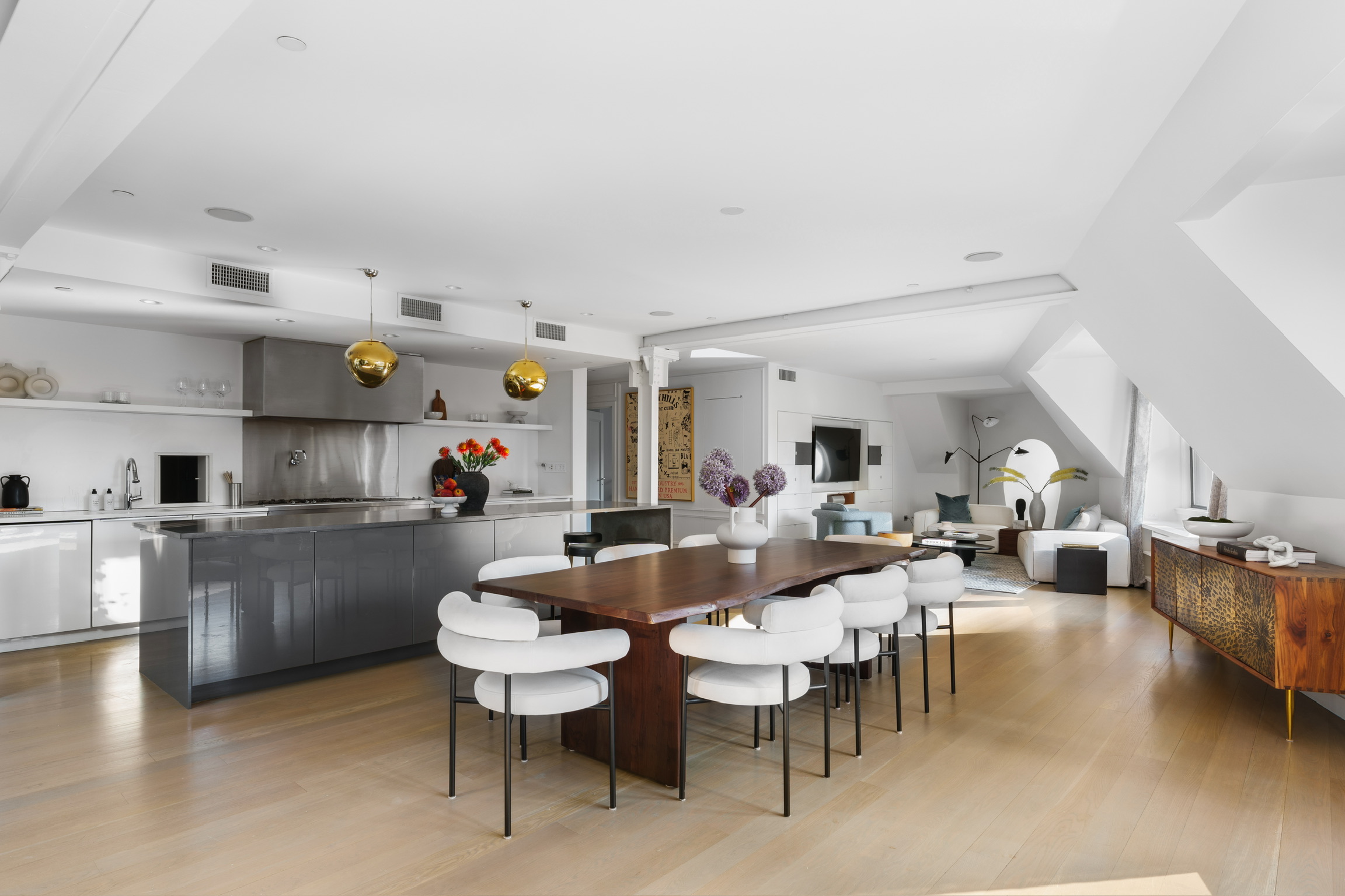 1200 Broadway, Unit PH89 Manhattan, NY 10001 - Photo 3 of 47 a very nice looking open dining room with kitchen island stainless steel appliances refrigerator stove a sink dishwasher and a dining table with garden view