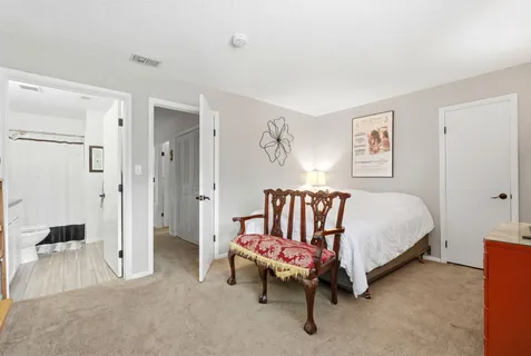 a bedroom with a bed a desk and chair