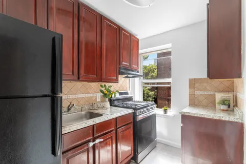 a kitchen with stainless steel appliances granite countertop a refrigerator stove and sink