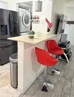 a kitchen with a refrigerator and a stove