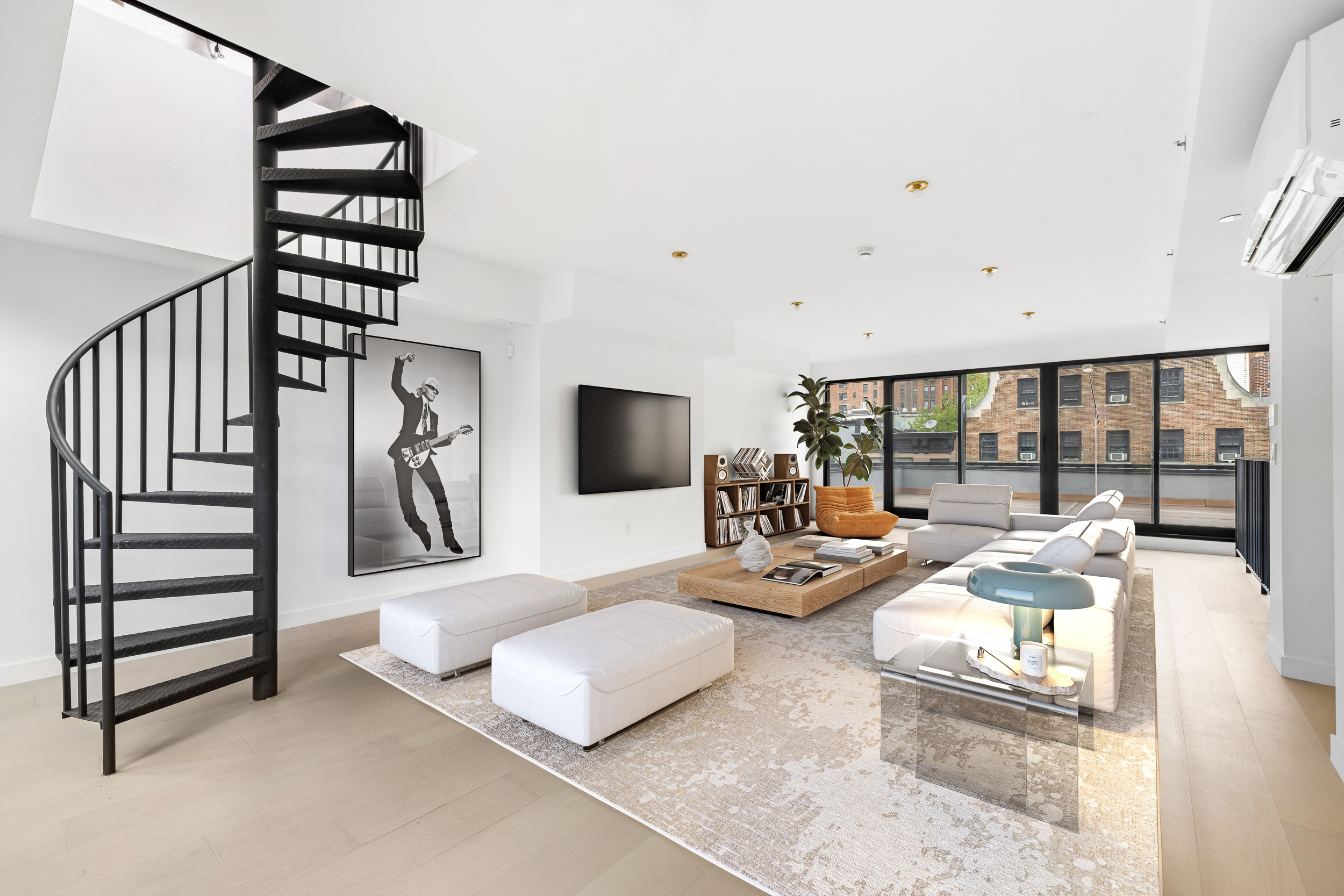 442 West 22nd Street Manhattan, NY 10011 - Photo 15 of 17 a bedroom with furniture and a large window