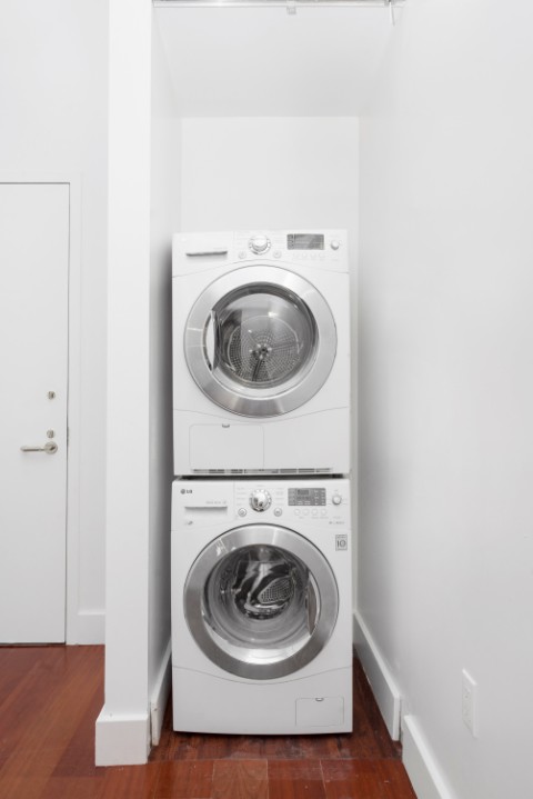 80 John Street, Unit 4C Manhattan, NY 10038 - Photo 10 of 11 a utility room with washing machine