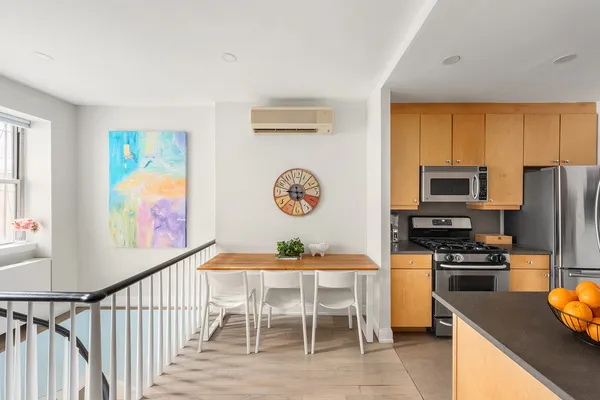 a dining room with furniture and a window