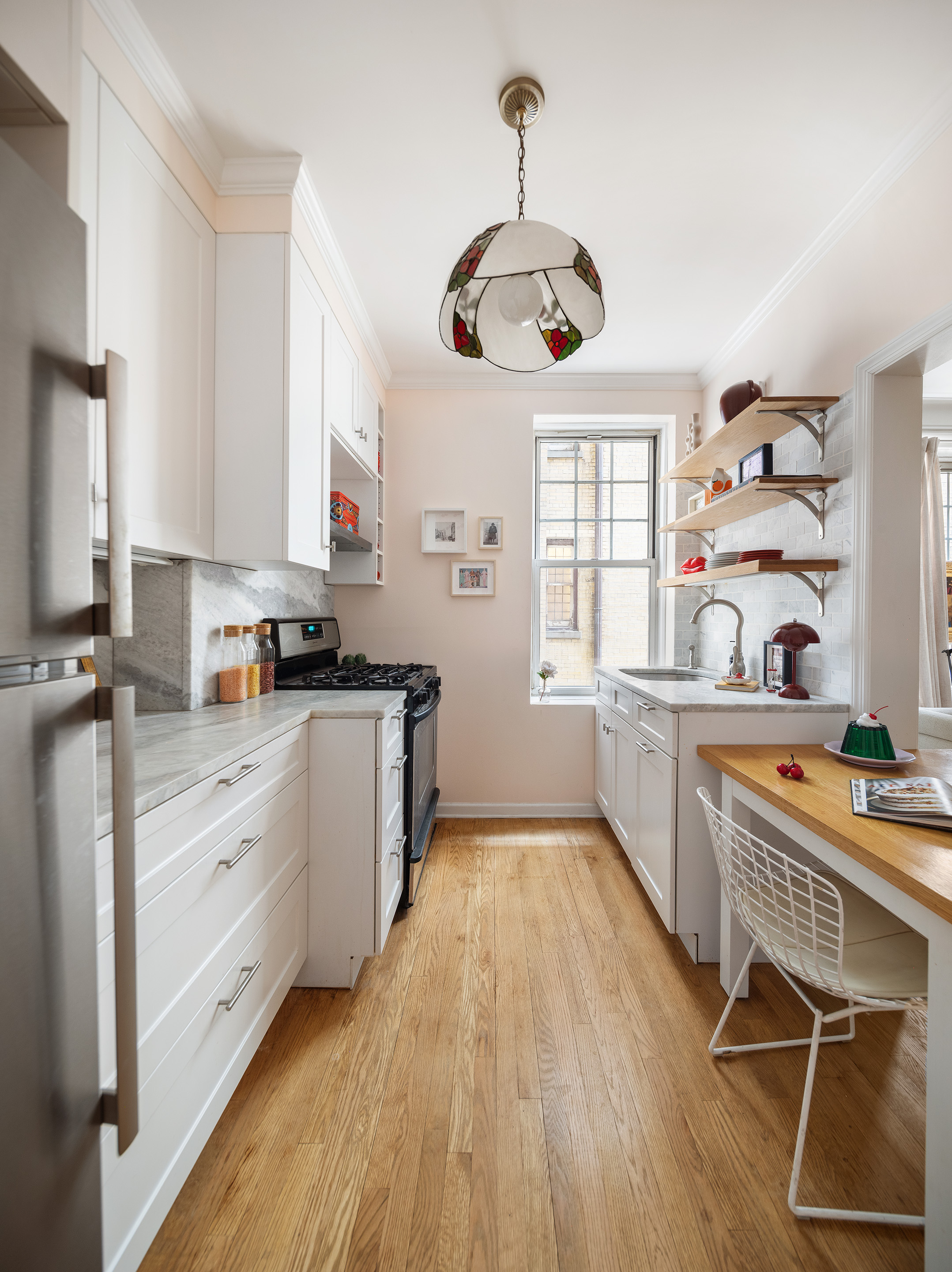 125 Prospect Park West, Unit 2E Brooklyn, NY 11215 - Photo 9 of 14 a kitchen with stainless steel appliances a stove a sink a cabinets and wooden floor