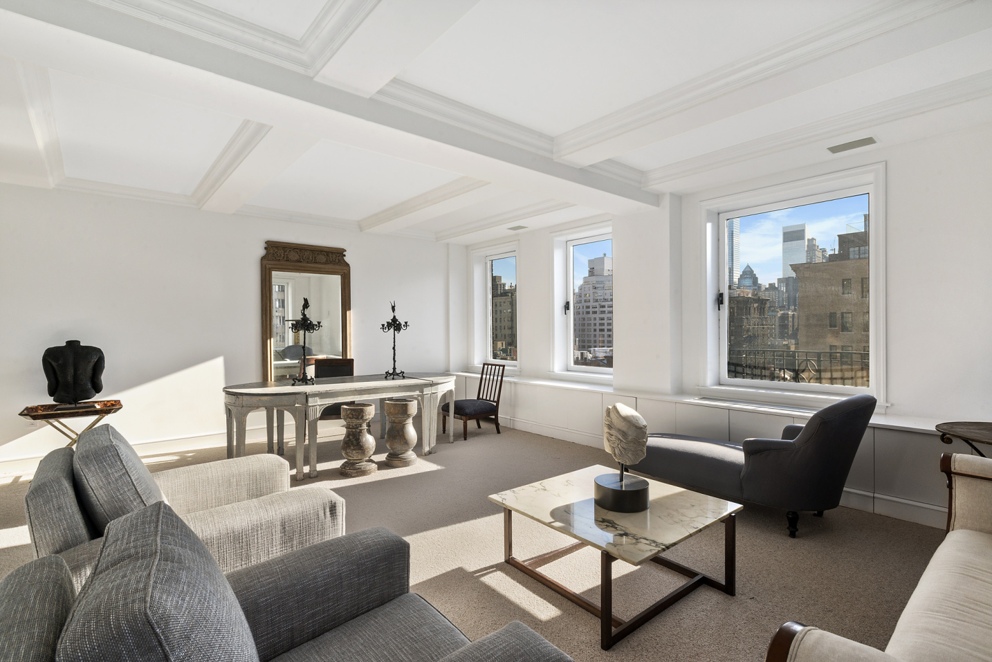 15 East 69th Street, Unit 10D Manhattan, NY 10021 - Photo 1 of 12 a living room with furniture and a potted plant on table