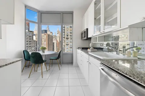 a kitchen with granite countertop a sink and a stove