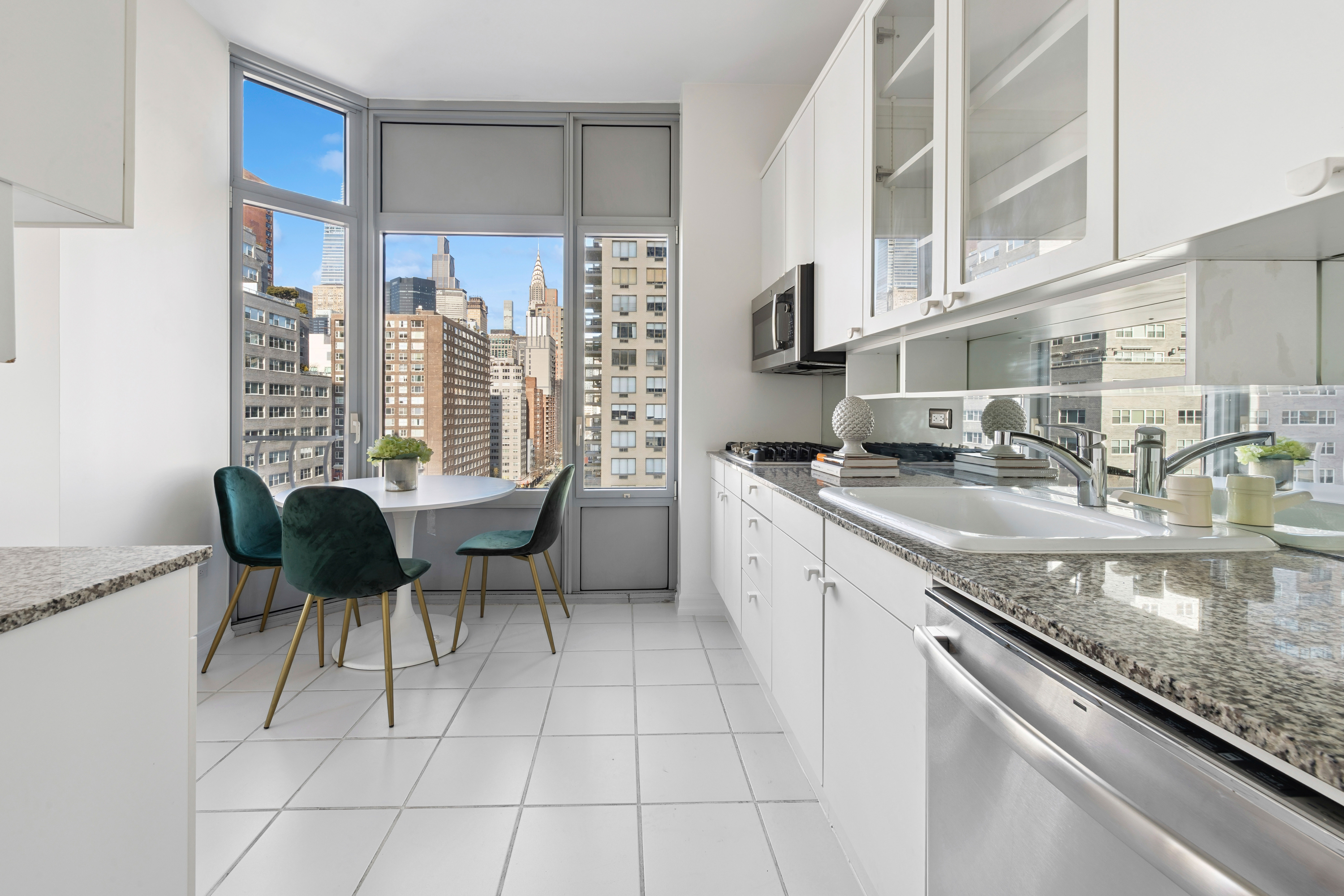 200 East 32nd Street, Unit 11D Manhattan, NY 10016 - Photo 8 of 19 a kitchen with granite countertop a sink and a stove