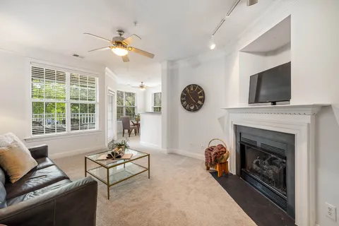 a living room with furniture a fireplace and a flat screen tv