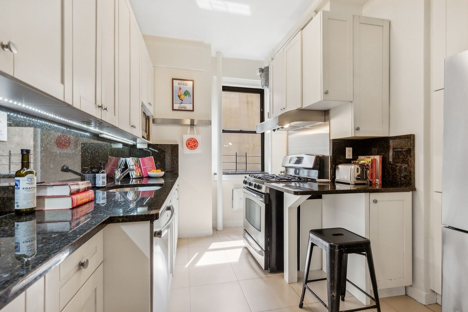 a kitchen with stainless steel appliances granite countertop a stove and a refrigerator