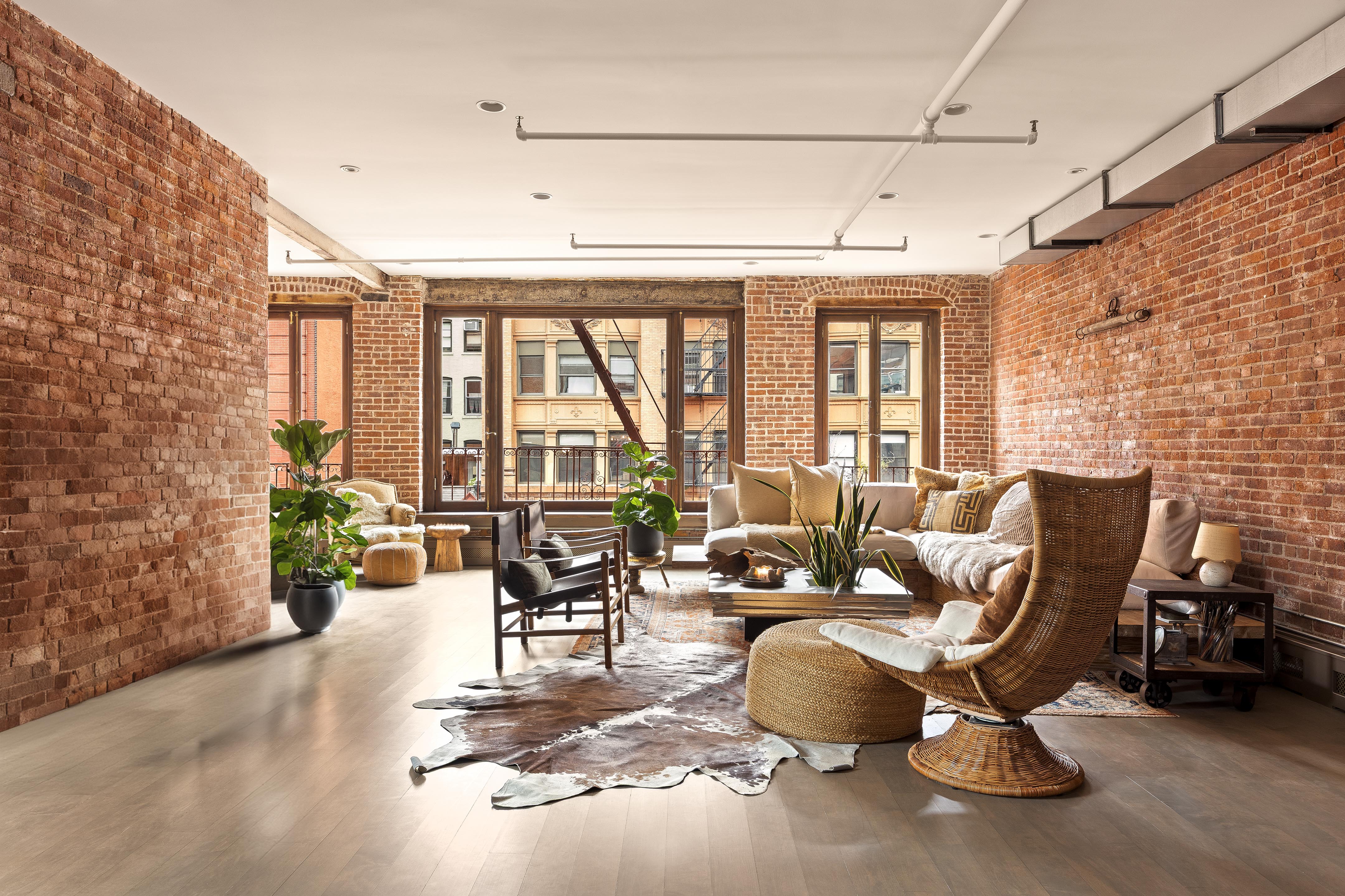 182 Lafayette Street, Unit 5 Manhattan, NY 10013 - Photo 1 of 19 a living room with furniture and floor to ceiling windows