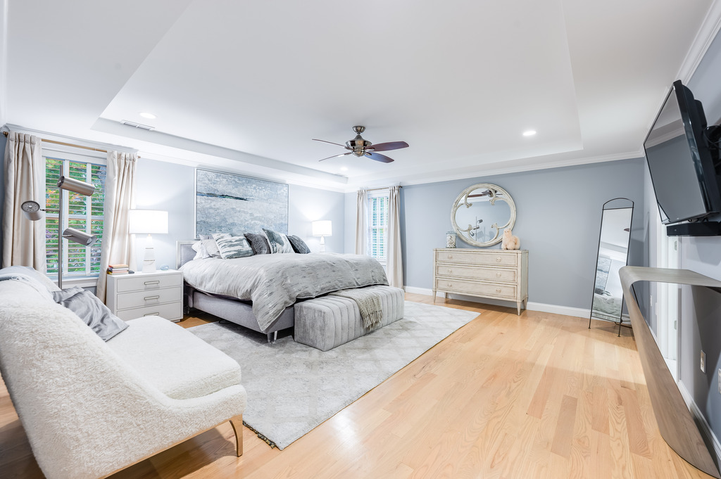 45 Washburn Avenue Needham, MA 02492 - Photo 10 of 23 a spacious bedroom with a bed a mirror and a flat tv screen