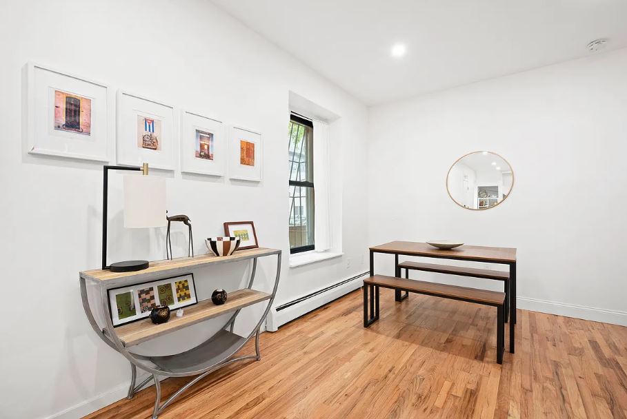 400 West 154th Street, Unit 1 Manhattan, NY 10032 - Photo 3 of 10 a living room with furniture and a wooden floor
