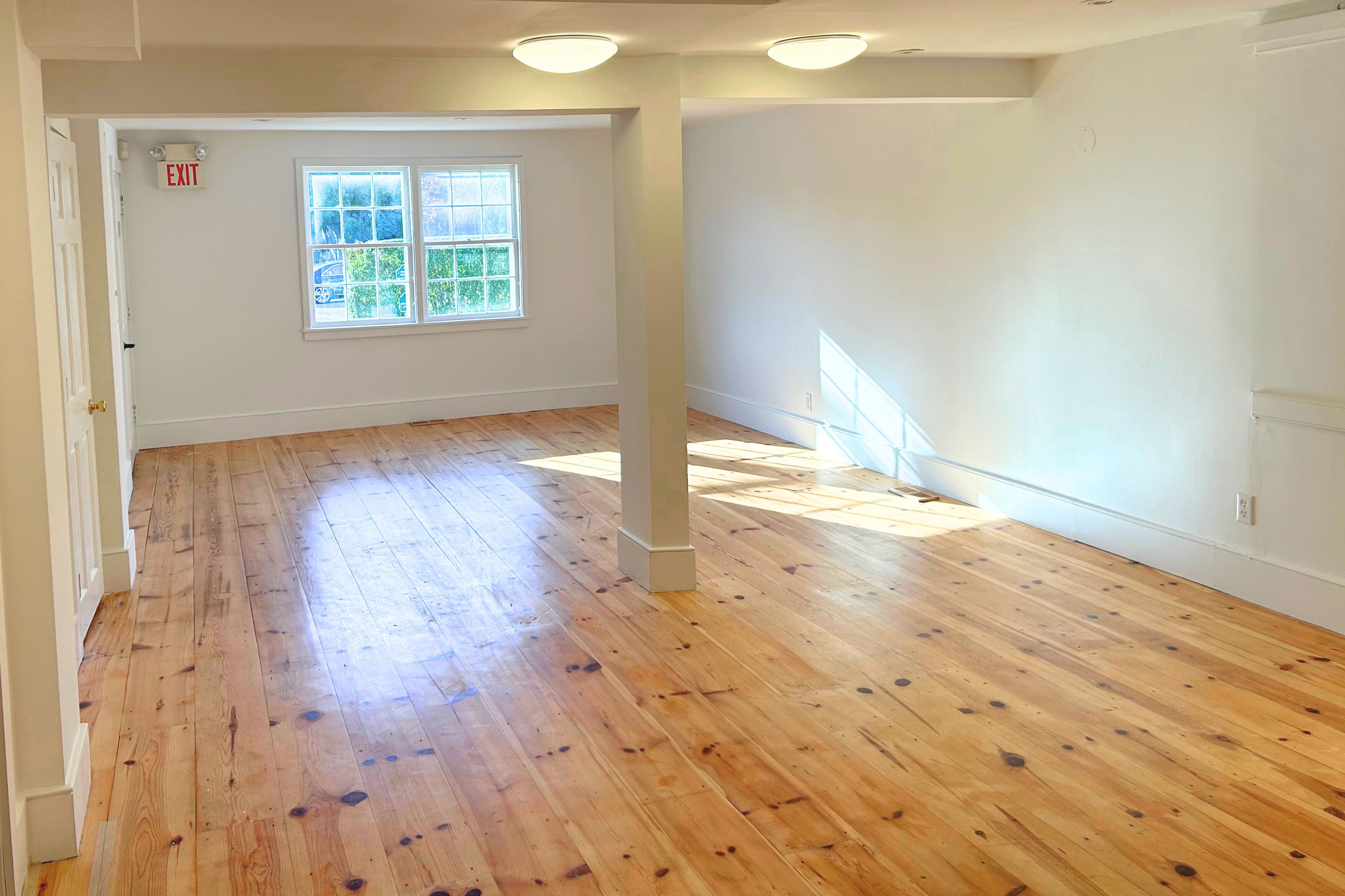 23 Bridge Street Sag Harbor, NY 11963 - Photo 15 of 25 an empty room with wooden floor and windows