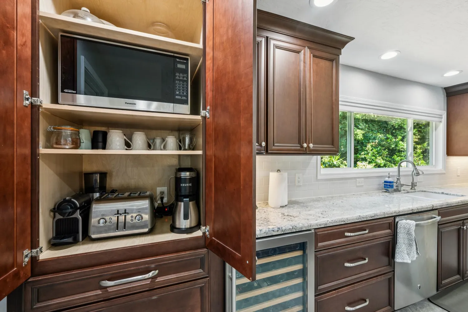 a bathroom with a granite countertop toilet a sink and a mirror