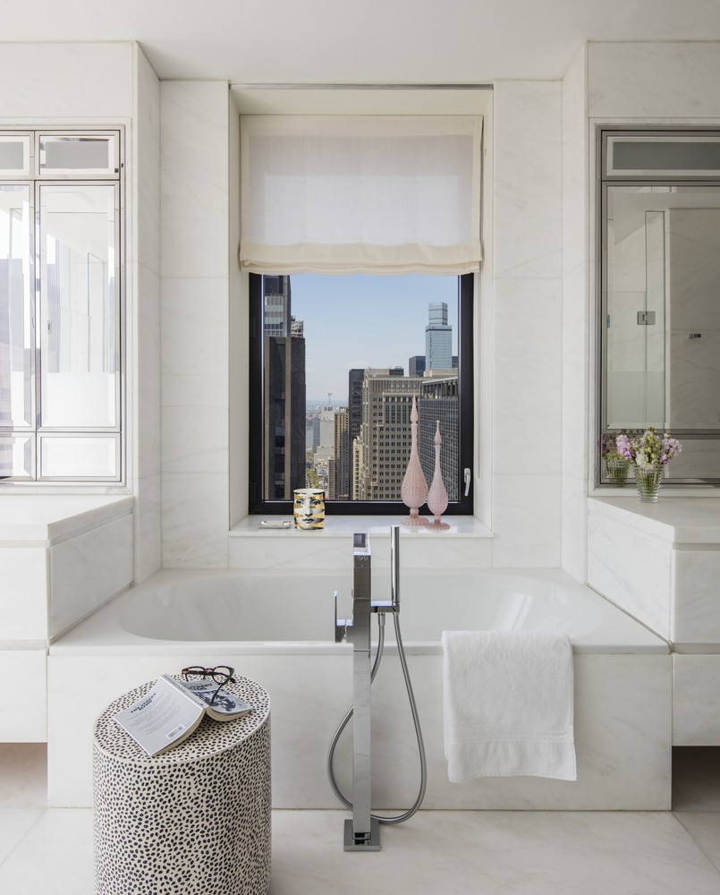 20 West 53rd Street, Unit 42A Manhattan, NY 10019 - Photo 11 of 31 a bathroom with a tub sink and mirror