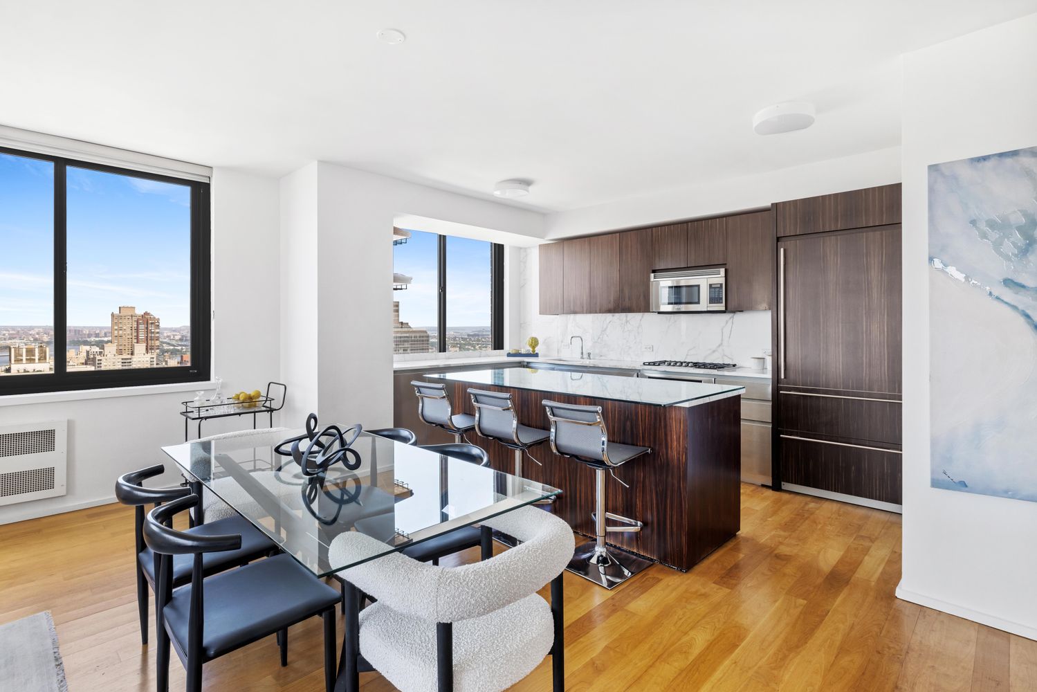 a kitchen with a table chairs refrigerator and microwave