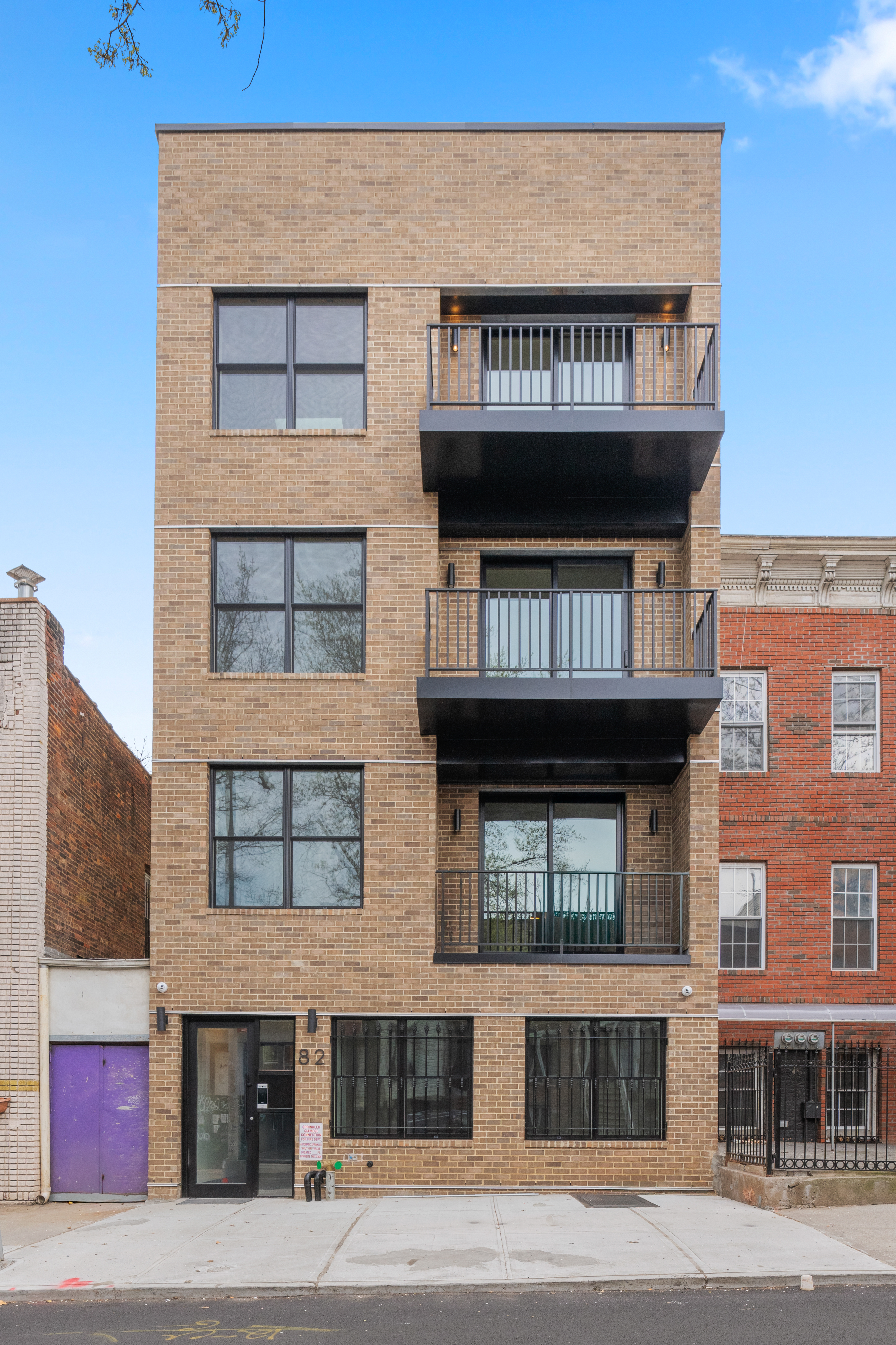 82 Cooper Street, Unit 2B Brooklyn, NY 11207 - Photo 16 of 17 a view of a brick building with many windows