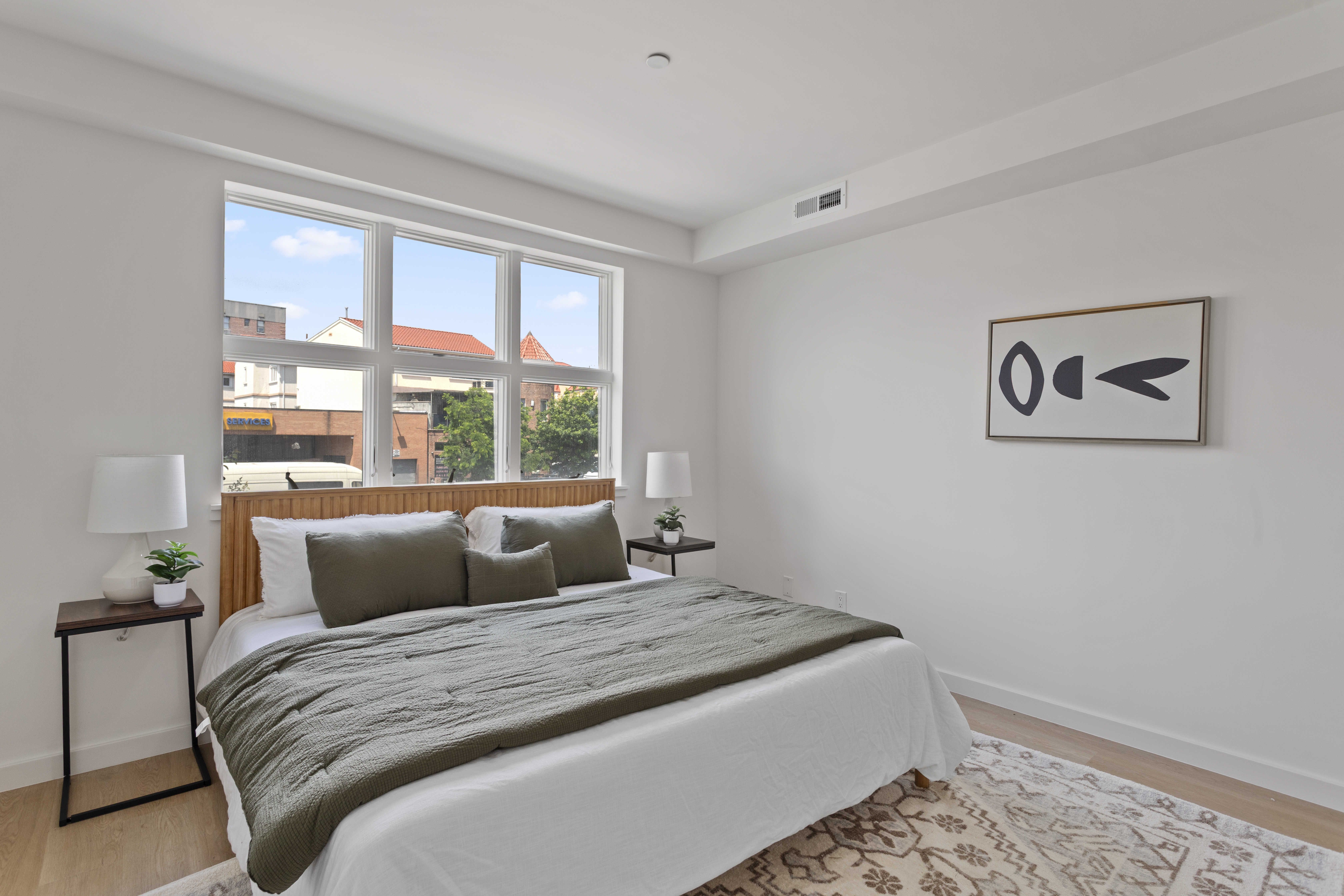 3112 Emmons Avenue, Unit 104 Brooklyn, NY 11235 - Photo 7 of 12 a bedroom with a large bed and a window