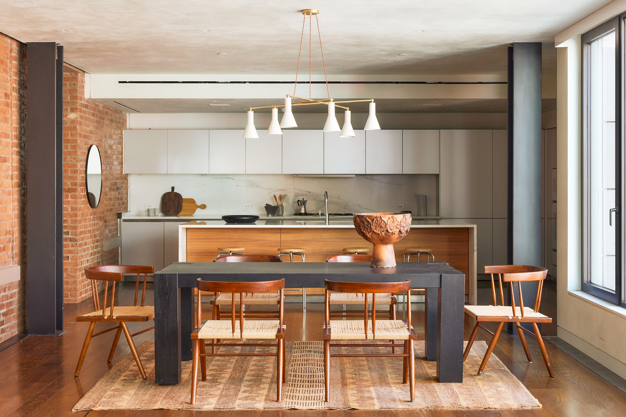 a kitchen with a table chairs and a refrigerator