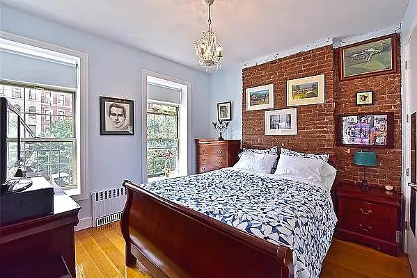 138 Edgecombe Avenue, Unit 3A Manhattan, NY 10030 - Photo 3 of 10 a bed sitting in a bedroom next to a window