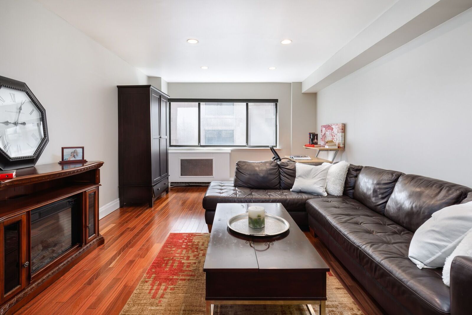 7 East 35th Street, Unit 10D Manhattan, NY 10016 - Photo 3 of 8 a living room with furniture and a fireplace