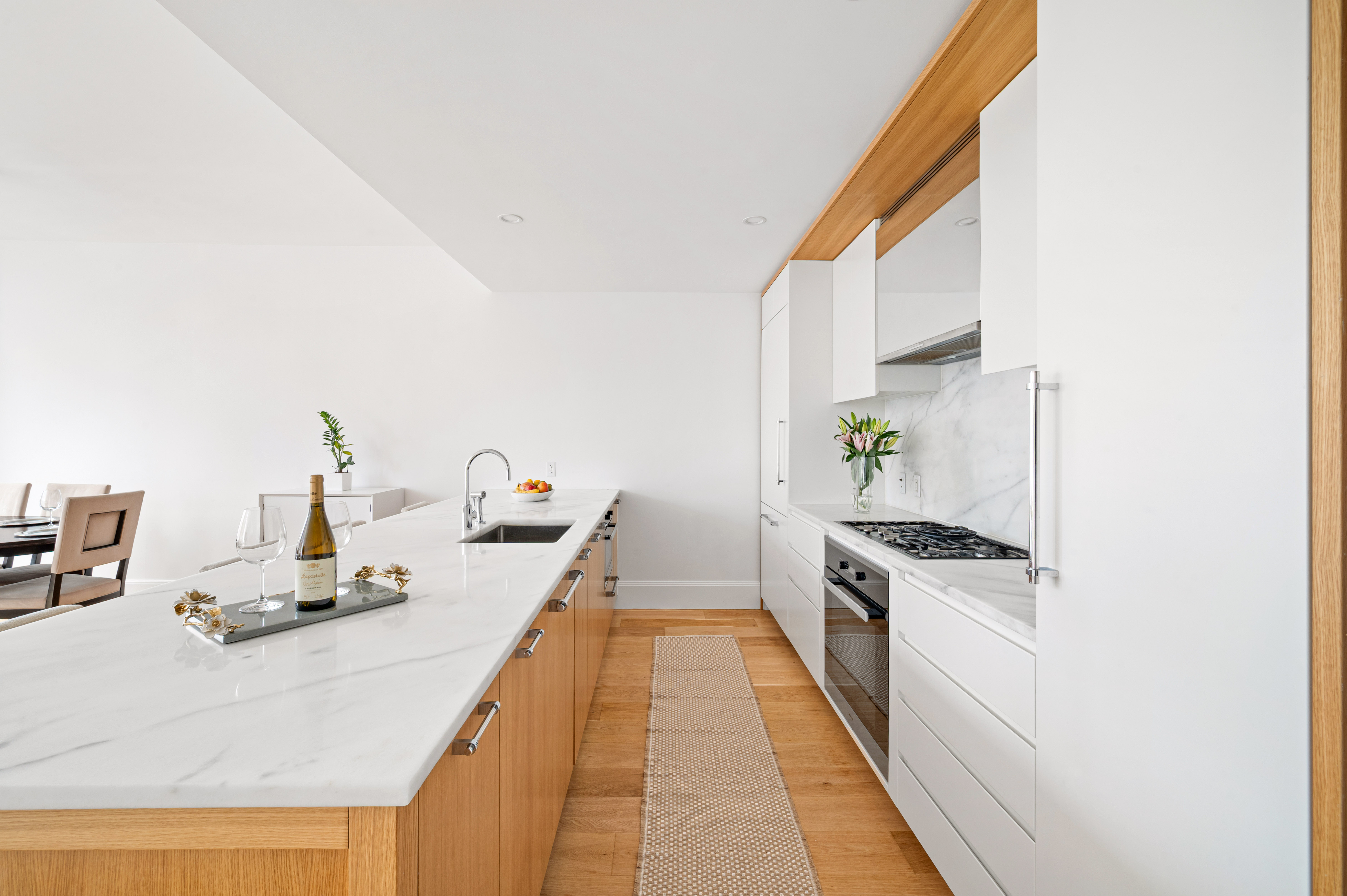 368 3rd Avenue, Unit 11AA Manhattan, NY 10016 - Photo 3 of 18 a kitchen with kitchen island a stove a sink and a refrigerator