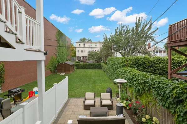 a view of a patio with couches table and chairs potted plants