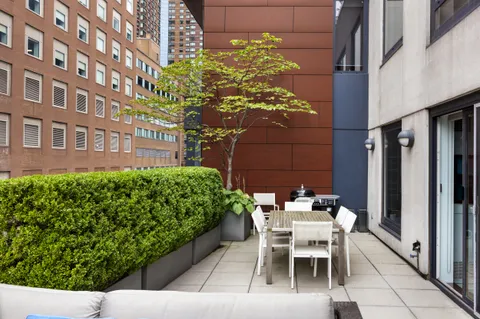a patio with table and chairs