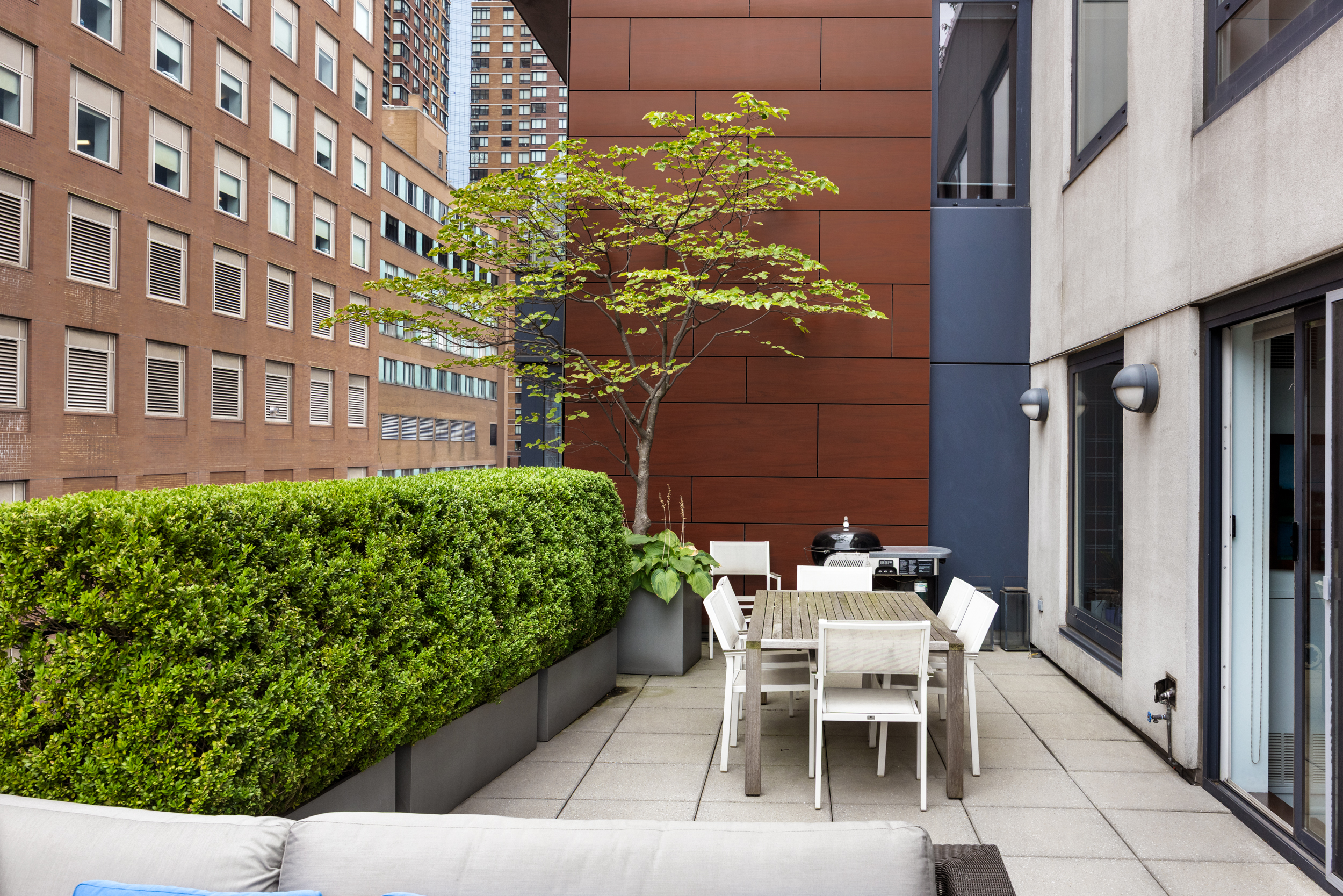462 West 58th Street, Unit 9B Manhattan, NY 10019 - Photo 7 of 17 a patio with table and chairs