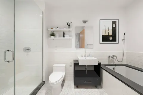 a bathroom with a sink toilet and shower