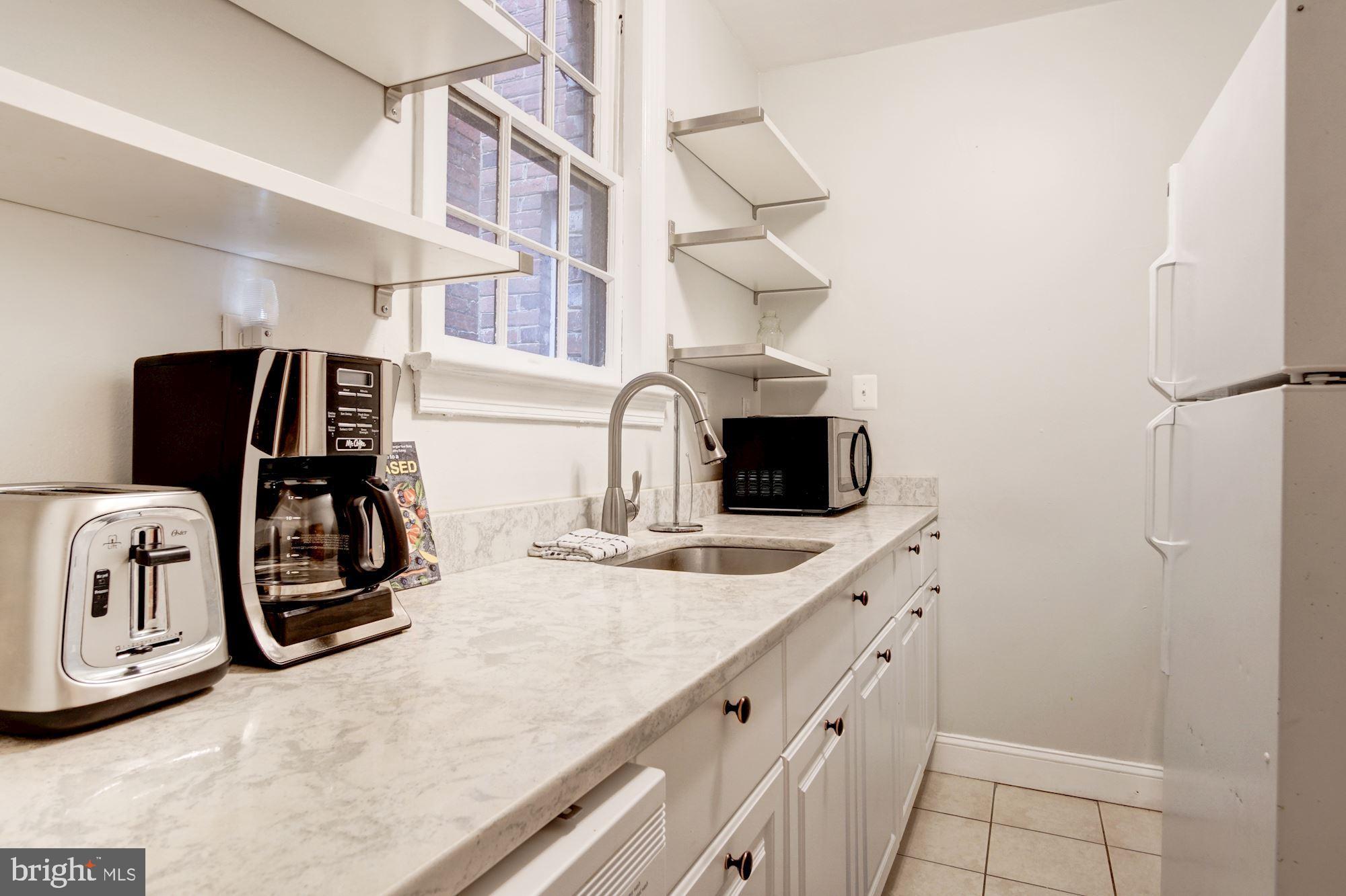 731 13th Street Northeast Washington, DC 20002 - Photo 31 of 43 a kitchen with cabinets and appliances