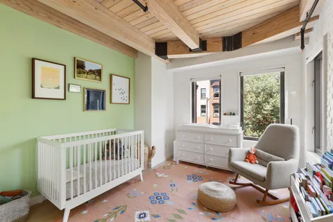 a bedroom with furniture and a window