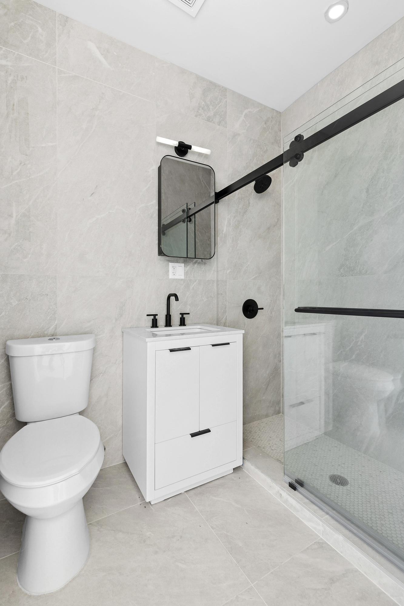 647 Dekalb Avenue, Unit 4B Brooklyn, NY 11216 - Photo 6 of 8 a bathroom with a toilet sink and shower