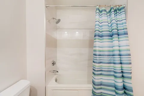 a bathroom with a shower and a bathtub