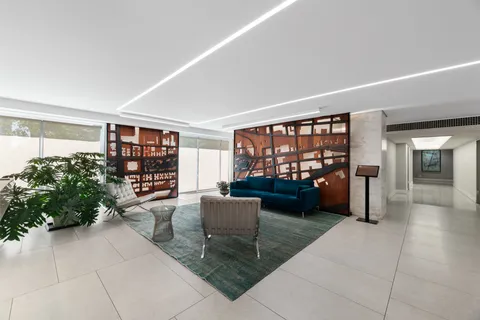 a living room with furniture and a book shelf