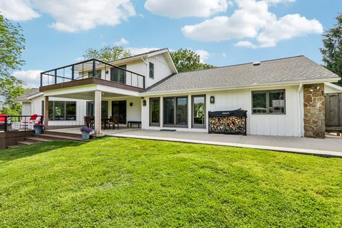 a view of a house with sitting area and garden