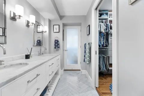 a spacious bathroom with a granite countertop sink and a mirror
