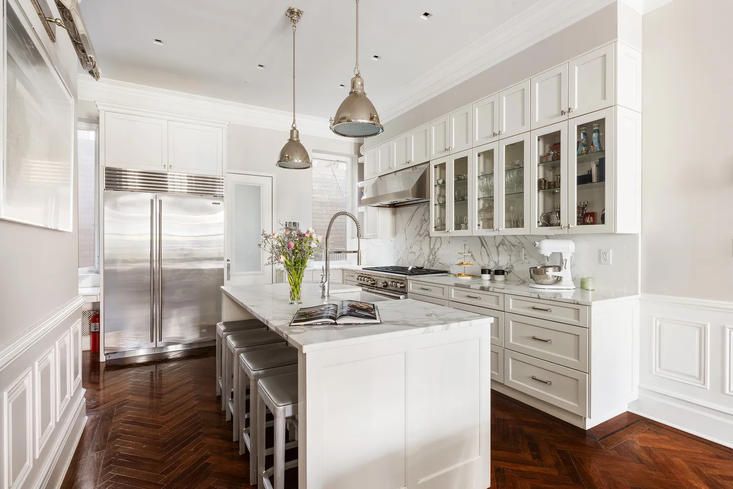 a kitchen with stainless steel appliances granite countertop a sink a stove and a wooden floors