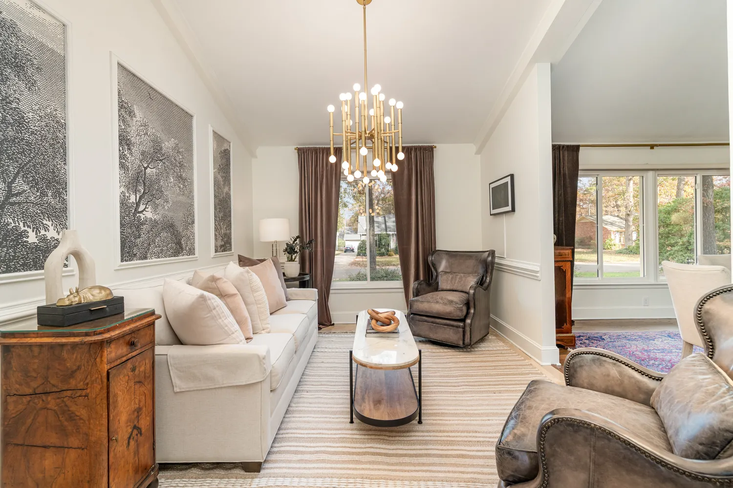 a living room with furniture and a chandelier