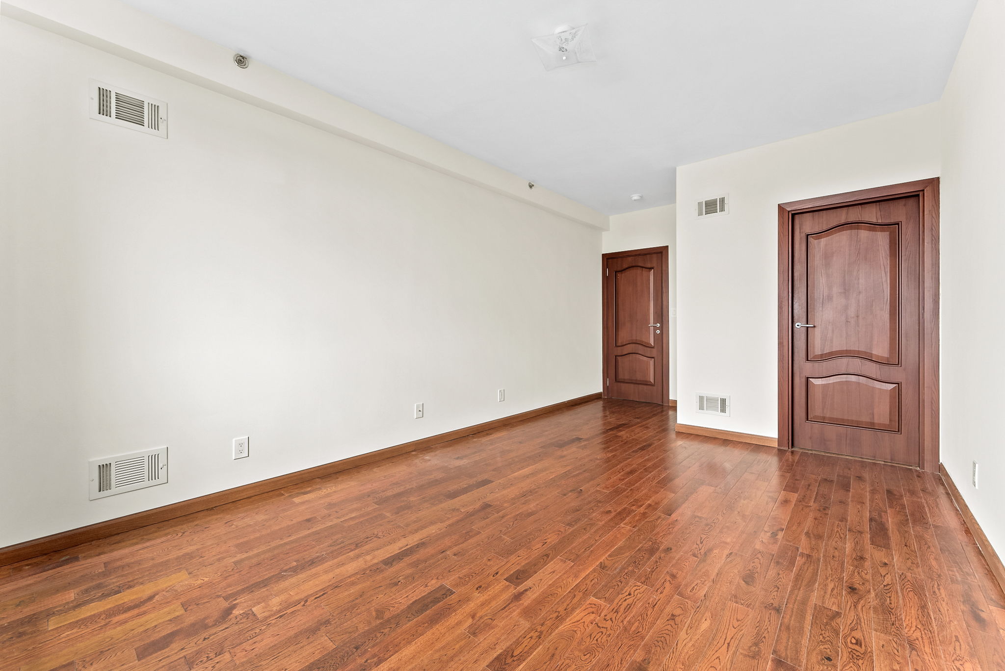 842 Ocean Parkway, Unit 8B Brooklyn, NY 11230 - Photo 9 of 14 a view of empty room with wooden floor and fan