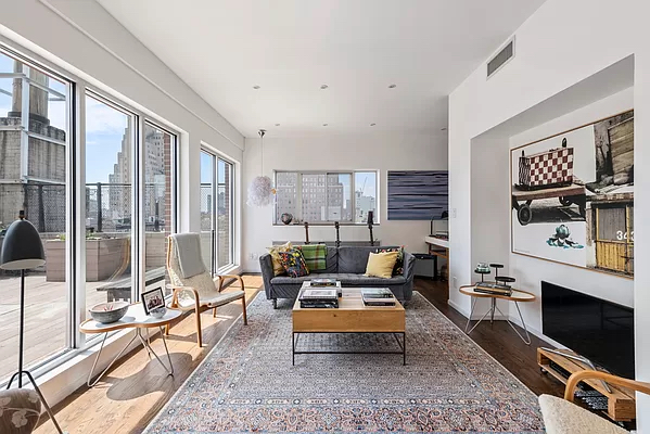210 West 16th Street, Unit PH Manhattan, NY 10011 - Photo 1 of 16 a living room with furniture a rug and a floor to ceiling window